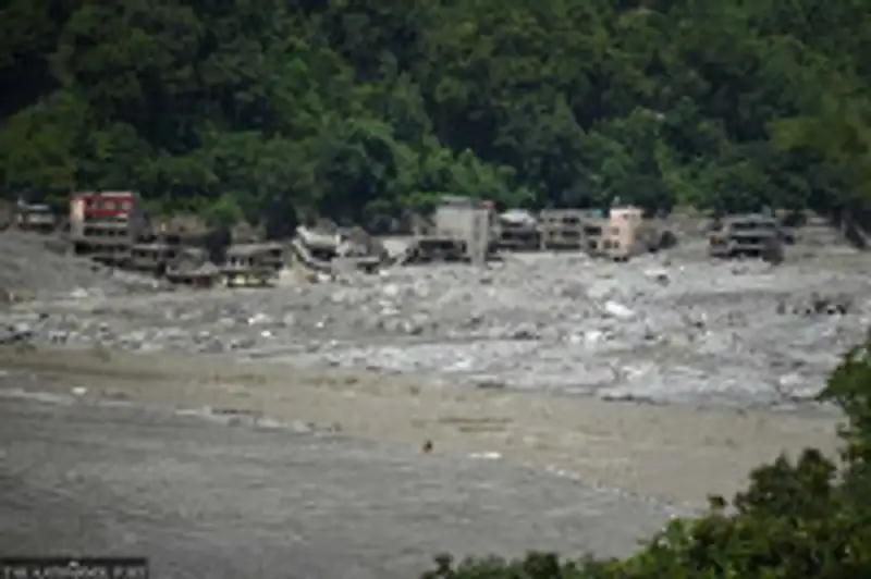 Destroyed homes and debris along a river after flooding in Nepal