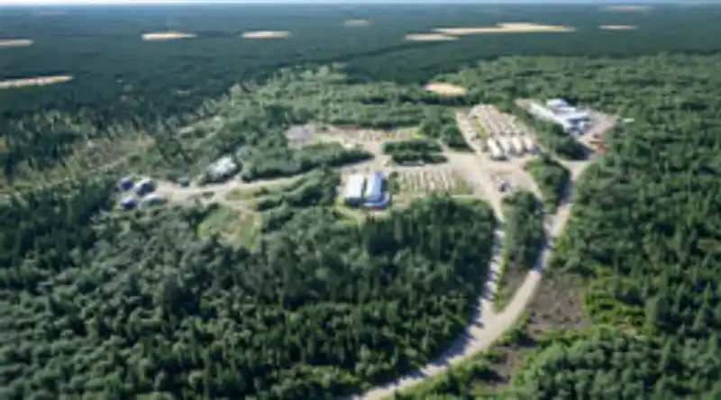 A tethered surveillance drone hovers above a ground station during a defense demonstration