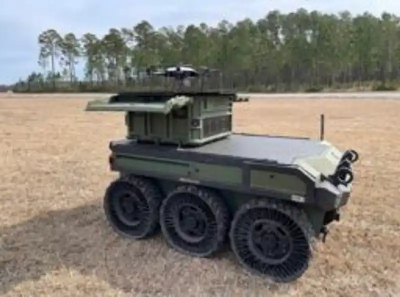 An unmanned ground vehicle carrying a drone launch box during field trials