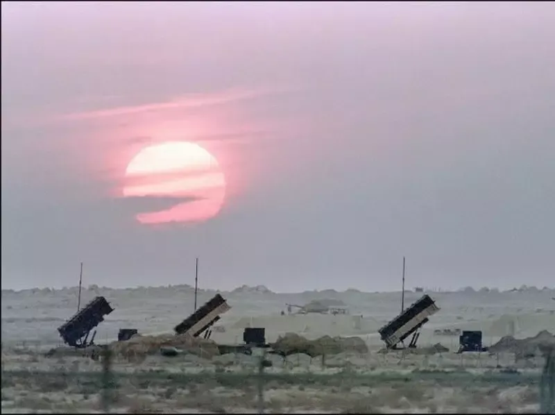 Military drone flying above desert terrain during regional aerial surveillance operations